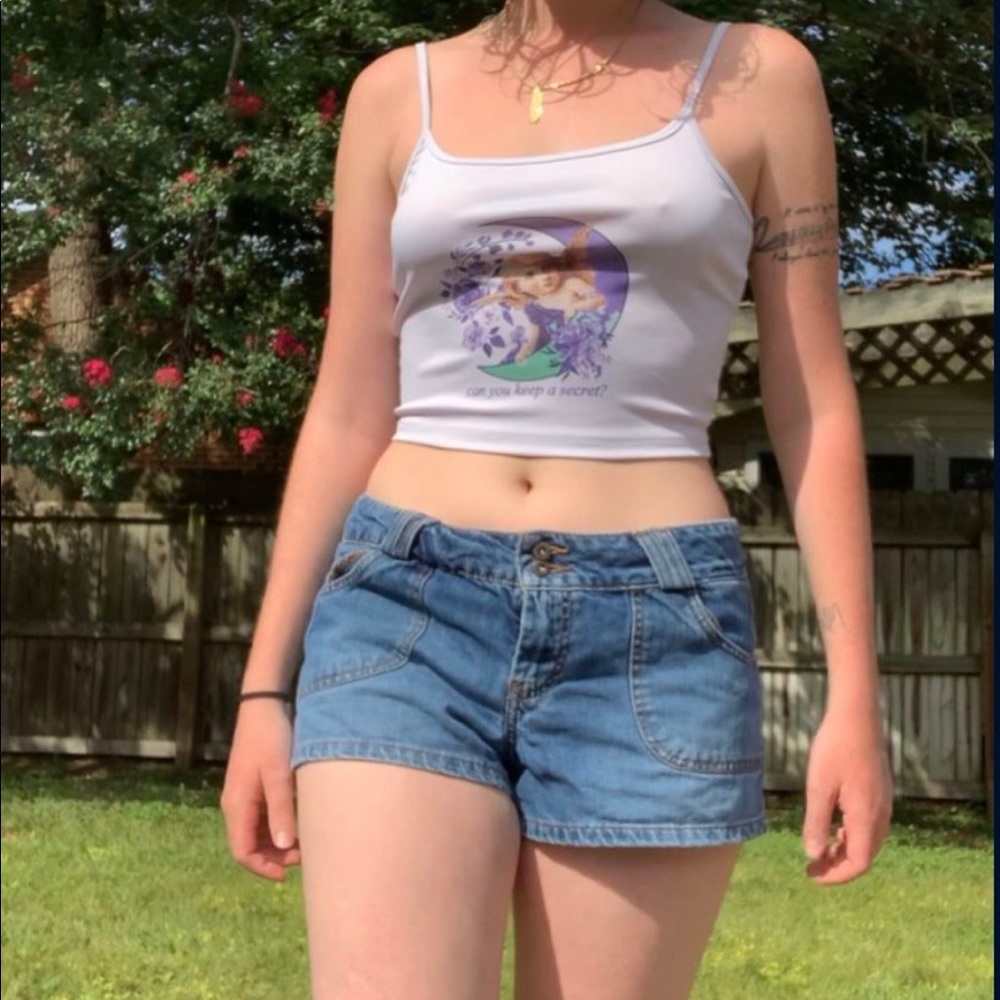 “Can you keep a secret?” white tank top